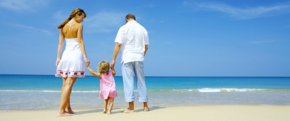 Family on a beach to illustrate article about accidents on holiday